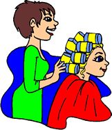female hair stylist olacing hair curlers on lady in salon chair